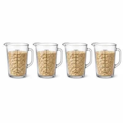 Four measuring cups each about three quarters full of oats.